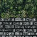 Drone shot showing rows of abandoned trucks at the edge of a forest, England, United Kingdom - stock photo